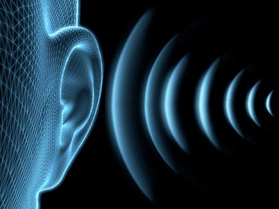 Illustration of an ear with sound waves going into it.