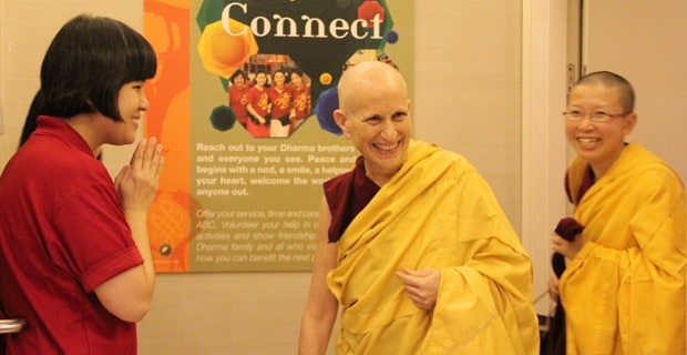 Ven. Chodron smiling and entering the centre with Ven. Damcho.