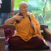 Venerable making a hand gesture while teaching.