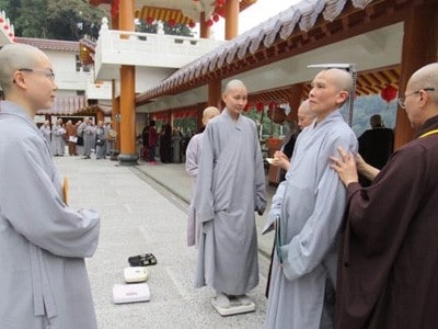 Venerable Pende being measured for monastic robes.