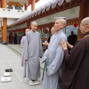 Venerable Pende being measured for monastic robes.