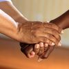Someone holding another person's hand in supportive gesture.
