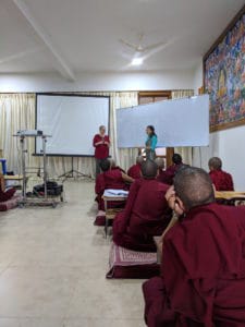 Two women teaching Tibetan nuns.