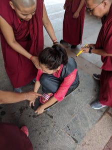 Tibetan nuns performing an experiment for class.