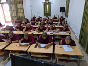 Tibetan nuns in class taking a test.