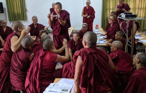 Tibetan nuns discussing physics experiments in class.