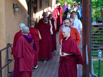 Group of monastics and laypeople doing walking meditation.
