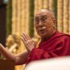 His Holiness teaching and gesturing with hands.
