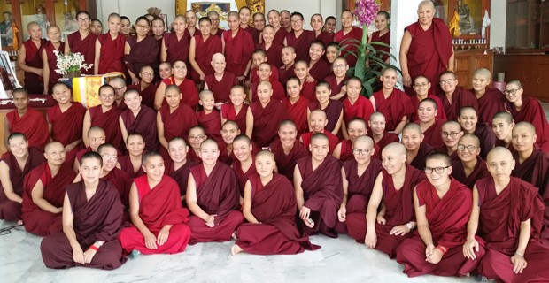 A large group of monastics posing for a photo.