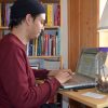 Dharma student looking at laptop computer.