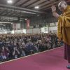 Social action and interfaith dialogue His Holiness the Dalai Lama waving to a large crowd at a teaching.