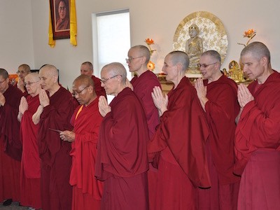 Group of monastics with palms together.