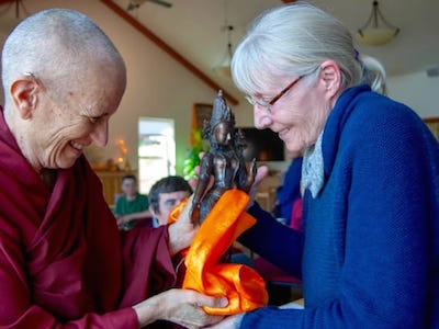 Venerable Chodron offering a gift to a student at the Abbey.