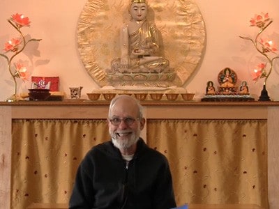 Bob giving a talk at Sravasti Abbey in front of the Chenrezig Hall altar.