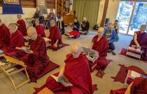 A group of monastics and laypeople practicing in the meditation hall at Sravasti Abbey.