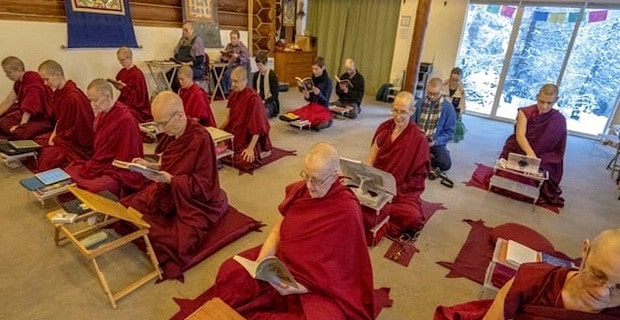 A group of monastics and laypeople practicing in the meditation hall at Sravasti Abbey.