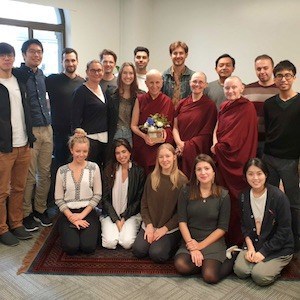 Group photo of Venerables Chodron, Chonyi, and Samten standing with the staff of Insight Timer Sydney.