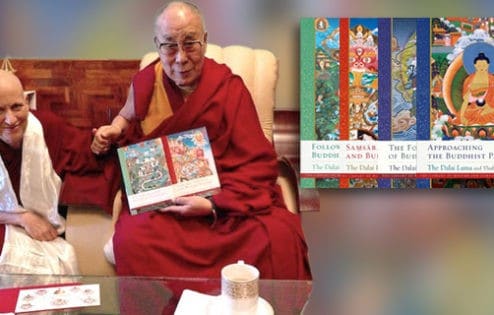 Venerable sitting next to His Holiness the Dalai Lama. His Holiness is hold two copies of the Library of Wisdom and Compassion.