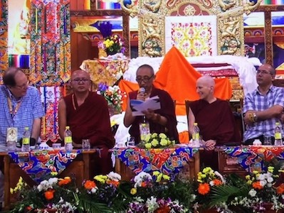 Venerable Chodron sitting with a panel of presenters.