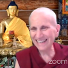 Venerable Chodron smiling in front of gold Buddha statue.
