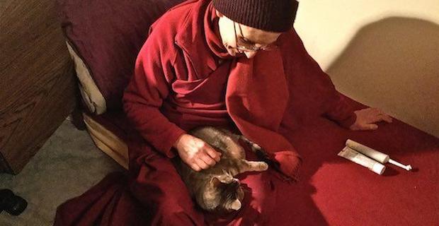 Venerable Tsepal with Mudita the cat in her lap.