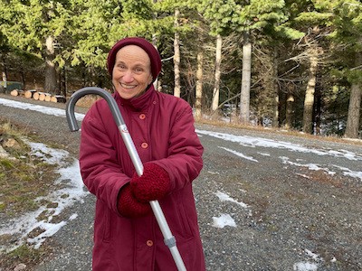 Venerable Thubten Chodron goes on a walk with a cane after recovering from hip surgery.