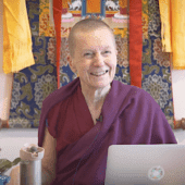 Venerable Sangye Khadro smiling while teaching in front of a thangka.