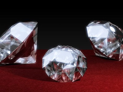 Three diamonds on a maroon colored cloth.