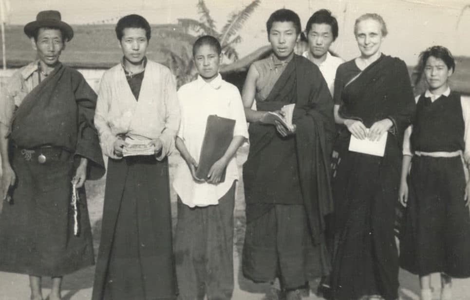 Freda Bedi standing with a group of Tibetans at Buxa.