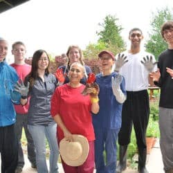Young Adult Week participants take a group photo in work clothes.