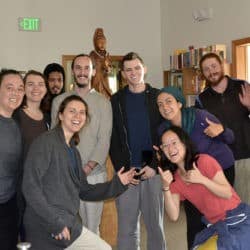 Young Adult Week participants pose in a group photo in front of the Kuan Yin statue in the Chenrezig Hall dining room.