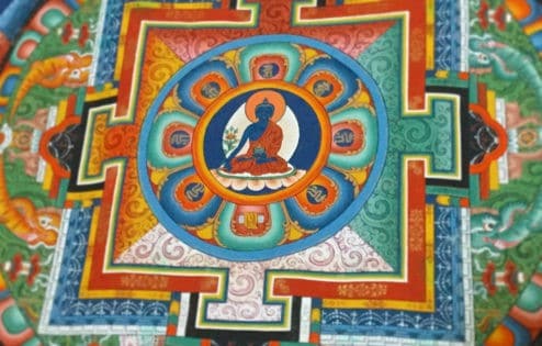 Medicine Buddha in a painted representation of the universe.