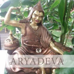 Copper statue of Aryadeva clapping his hands in debate.