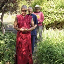 Venerable Kunga leads retreat participants in walking meditation in the Sravasti Abbey garden.