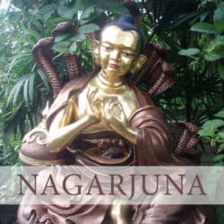 Copper statue of Nagarjuna with snakes behind him in a garden.