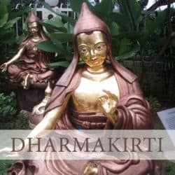 Copper statue of Dharmakirti in a garden.