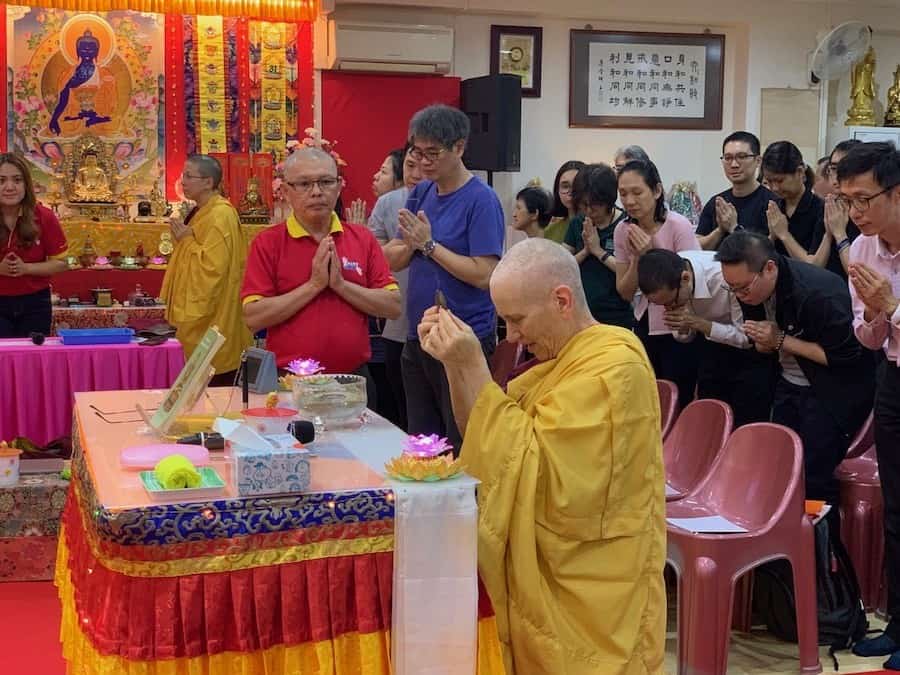 Venerable Chodron offers incense before giving a talk at Pureland Marketing in Singapore.