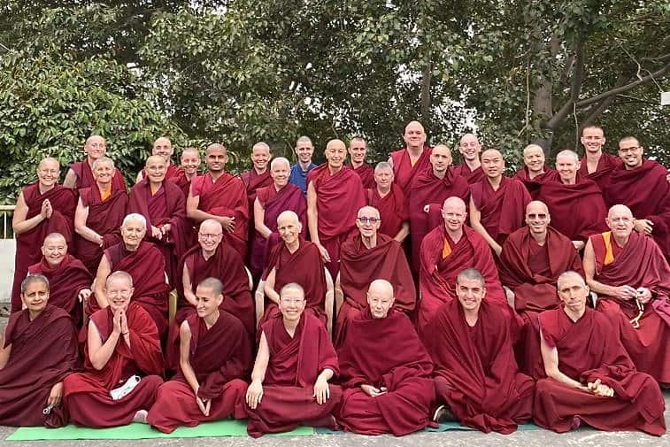 A large group of Tibetan monastics gathered together.
