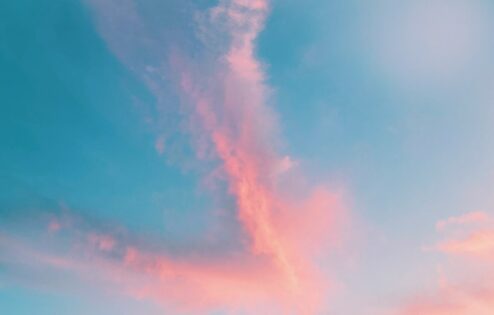 Pink clouds against a blue sky.