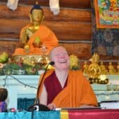 Ven. Sangye Khadro laughs in the teacher's seat of the Meditation Hall.