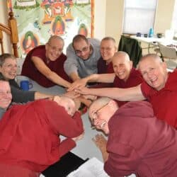 Sravasti Abbey residents pile their hands in the center in a display of harmony.
