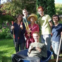 Young adults work outside in the garden with Ven. Chodron.