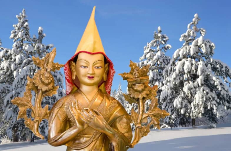 Statue of Lama Tsongkhapa surrounded by snowy trees